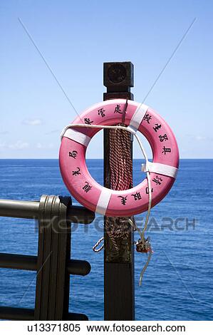 A pink life buoy on a rail beside the sea View Large Photo Image Stock Photography - A pink life buoy on a rail beside the sea. Fotosearch