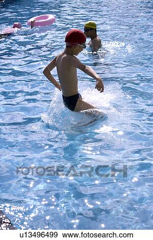 Boys playing in the swimming pool View Large Photo Image Stock Photo - Boys playing in the swimming pool. Fotosearch