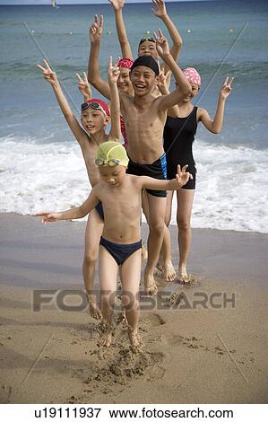 Children standing on the sand and playing happily View Large Photo Image Stock Photo - Children standing on the sand and playing happily. Fotosearch