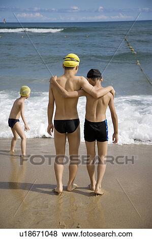 Three boys is walking towards the sea View Large Photo Image Stock Photo - Three boys is walking towards the sea. Fotosearch