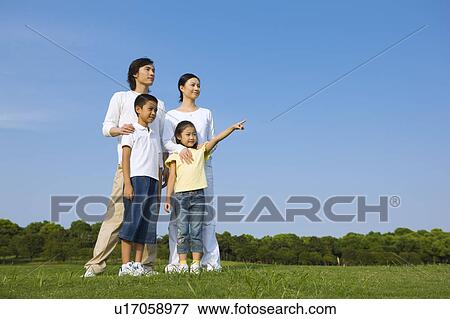 Family with two children standing on the lawn View Large Photo Image Stock Photo - Family with two children standing on the lawn. Fotosearch