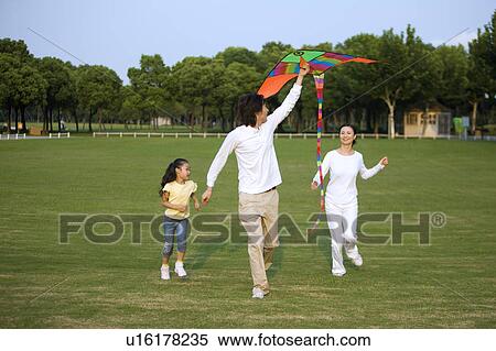 Young family with daughter flying a kite on the lawn View Large Photo Image Stock Photography - Young family with daughter flying a kite on the lawn. Fotosearch