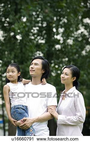 Young family with daughter looking away View Large Photo Image Stock Image - Young family with daughter looking away. Fotosearch