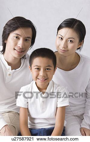Young family with son looking at the camera together View Large Photo Image Stock Image - Young family with son looking at the camera together. Fotosearch