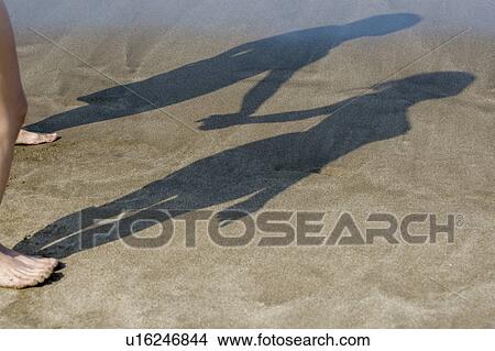 Shadow of young couple on the beach View Large Photo Image Picture - Shadow of young couple on the beach. Fotosearch