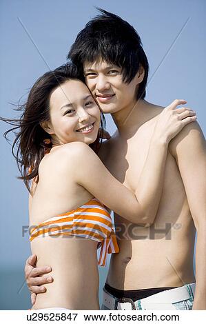 Young couple bonding together and looking at the camera View Large Photo Image Stock Photo - Young couple bonding together and looking at the camera. Fotosearch
