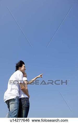 Stock Photograph - Young couple bonding together. Fotosearch
