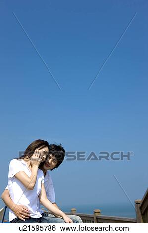Young couple outdoors by sea View Large Photo Image Stock Photograph - Young couple outdoors by sea. Fotosearch