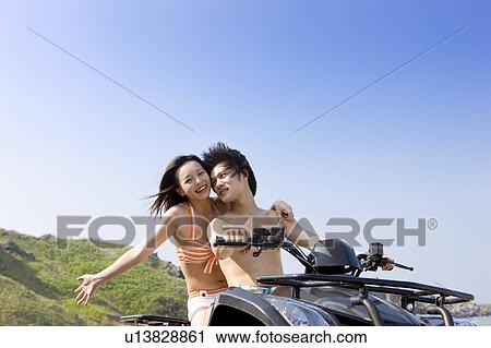 Young couple riding on the motorcycle View Large Photo Image Stock Image - Young couple riding on the motorcycle. Fotosearch