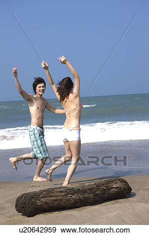 Young couple running on the beach View Large Photo Image Stock Photo - Young couple running on the beach. Fotosearch