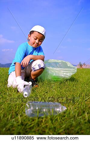 Little boy picking empty bottles up and putting into the garbage bag View Large Photo Image Stock Photography - Little boy picking empty bottles up and putting into the garbage bag. Fotosearch