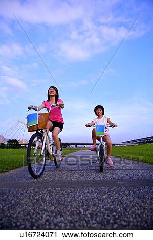 Mother with one child riding on the bicycle and smiling happily View Large Photo Image Stock Image - Mother with one child riding on the bicycle and smiling happily. Fotosearch