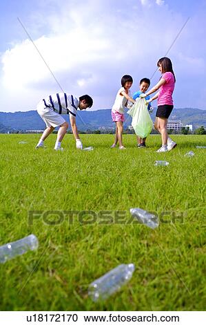 Young family with two children recycling wasted bottles on grass View Large Photo Image Stock Image - Young family with two children recycling wasted bottles on grass. Fotosearch