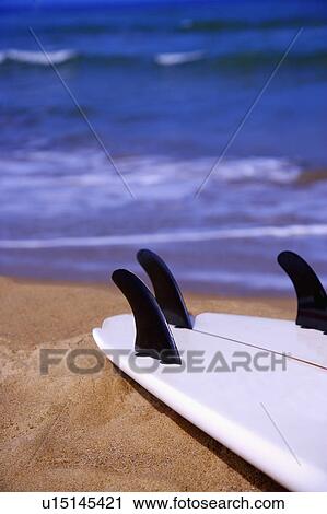 Stock Image - Close-up of a surfboard at beach. Fotosearch
