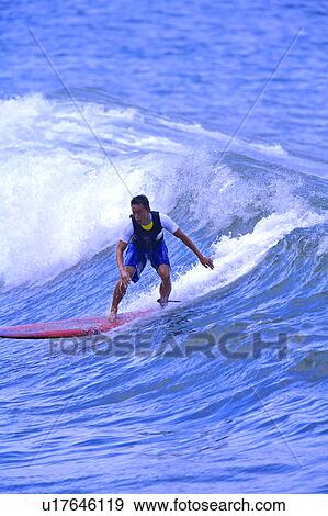 Stock Photo - Man surfing on the sea skillfully. Fotosearch