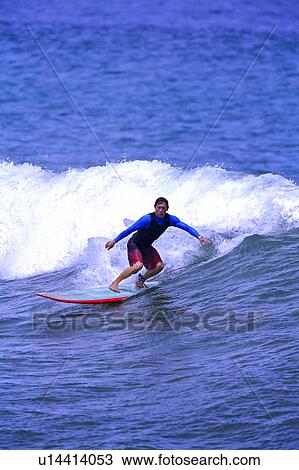 Man surfing on the sea skillfully with surf behind View Large Photo Image Stock Image - Man surfing on the sea skillfully with surf behind. Fotosearch