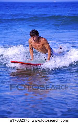 Stock Photography - Man surfing on the sea with the surfboard. Fotosearch