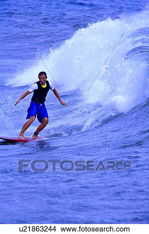Picture - Young surfer breaking through the sea. Fotosearch