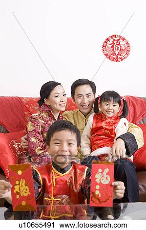 A family in traditional clothes celebrating Chinese New Year Stock