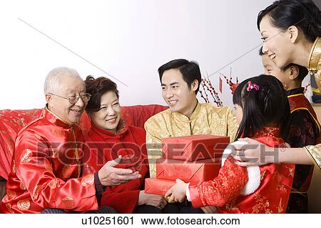 Children giving presents to grandparents to celebrating Chinese New Year View Large Photo Image Stock Image - Children giving presents to grandparents to celebrating Chinese New Year. Fotosearch