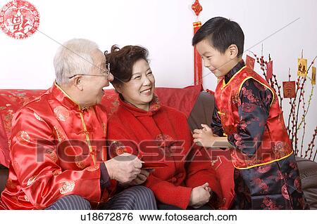 Elderly couple and little boy in traditional clothes smiling happily View Large Photo Image Stock Photograph - Elderly couple and little boy in traditional clothes smiling happily. Fotosearch