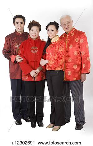 Family in traditional clothes smiling at the camera View Large Photo Image Stock Image - Family in traditional clothes smiling at the camera. Fotosearch