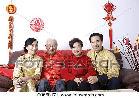 Family members in traditional clothes sitting on the sofa and smiling at the camera View Large Photo Image Stock Image - Family members in traditional clothes sitting on the sofa and smiling at the camera. Fotosearch