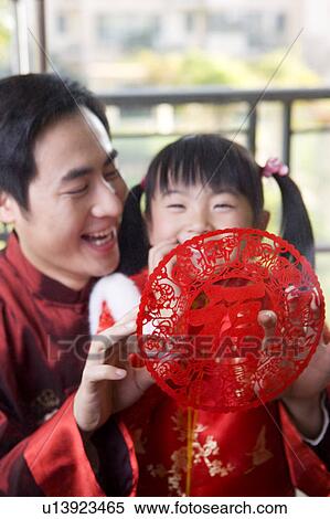 Young father holding the decoupage and smiling happily with little girl View Large Photo Image Stock Photography - Young father holding the decoupage and smiling happily with little girl. Fotosearch