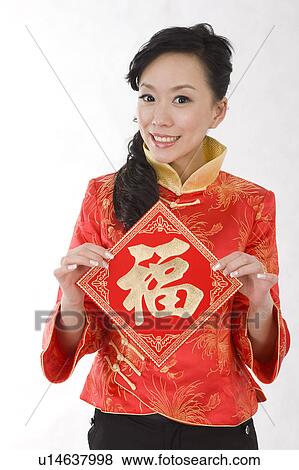 Young woman holding Chinese script and smiling at the camera View Large Photo Image Stock Photo - Young woman holding Chinese script and smiling at the camera. Fotosearch