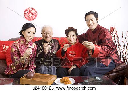 Family members in traditional clothing holding teacups and smiling at the camera View Large Photo Image Stock Photography - Family members in traditional clothing holding teacups and smiling at the camera. Fotosearch