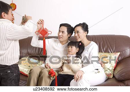 Little boy taking picture of young couple with a little girl View Large Photo Image Stock Image - Little boy taking picture of young couple with a little girl. Fotosearch