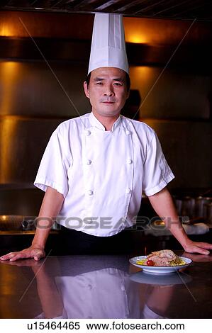 Stock Photography - Chef standing and looking at the camera. Fotosearch