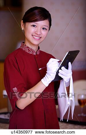 Young waitress writing menu and smiling at the camera View Large Photo Image Stock Photo - Young waitress writing menu and smiling at the camera. Fotosearch