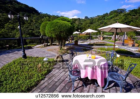Stock Photograph - Beautiful scenery and outdoor space of modern style in a garden restaurant. Fotosearch