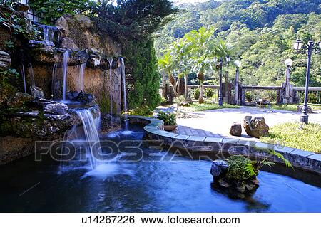 Stock Photograph - Beautiful scenery of outdoor space and waterfall. Fotosearch