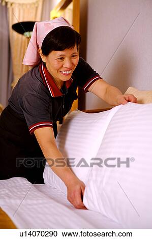 Waitress cleaning the room in the hotel and smiling View Large Photo Image Stock Image - Waitress cleaning the room in the hotel and smiling. Fotosearch