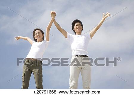 Stock Photo - Japanese couple below the blue sky. Fotosearch