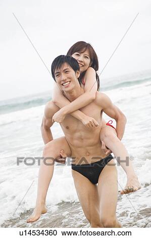 Japanese man carrying lover on his back View Large Photo Image Stock Image - Japanese man carrying lover on his back. Fotosearch