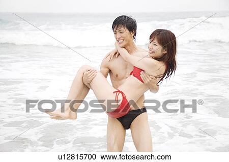 Japanese man lifting up lover View Large Photo Image Stock Image - Japanese man lifting up lover. Fotosearch