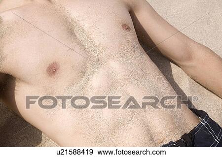 Japanese man lying on a beach View Large Photo Image Stock Photo - Japanese man lying on a beach. Fotosearch