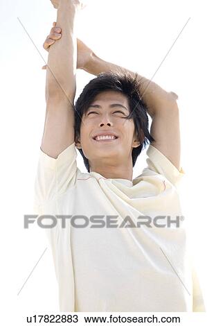 Japanese man stretching arms View Large Photo Image Stock Image - Japanese man stretching arms. Fotosearch
