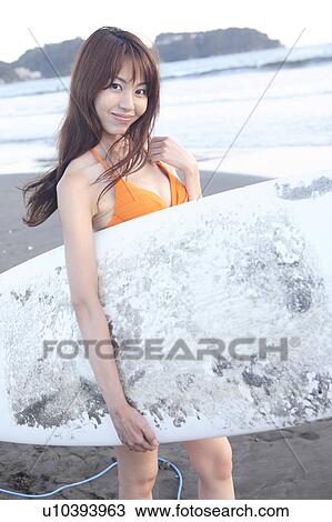 Stock Image - Japanese surfer in Enoshima beach. Fotosearch