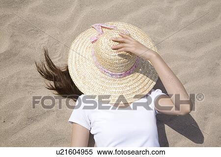 Stock Photography - Japanese woman lying on a beach. Fotosearch