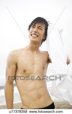 Stock Photo - Portrait of Japanese young man in swimsuit. Fotosearch