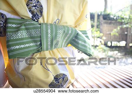 Back figure of Japanese woman putting on a yukata View Large Photo Image Picture - Back figure of Japanese woman putting on a yukata. Fotosearch