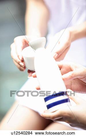 Hand of woman pouring a Japanese sake View Large Photo Image Picture - Hand of woman pouring a Japanese sake. Fotosearch