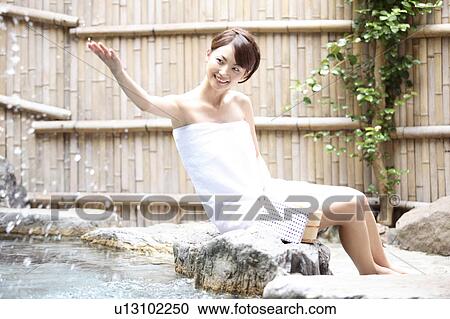 Stock Image - Japanese woman at the open-air bath. Fotosearch
