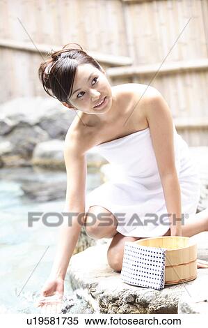 Stock Photography - Japanese woman at the open-air bath. Fotosearch