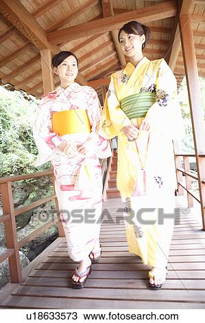 Stock Image - Japanese woman putting on a yukata. Fotosearch