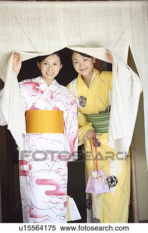 Japanese woman putting on a yukata View Large Photo Image Stock Photography - Japanese woman putting on a yukata. Fotosearch
